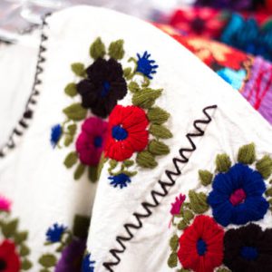 Colorful Embroidered Mexican Blouses at Market (Close-Up)